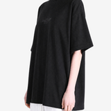 Black t-shirt worn by a person, showing the t-shirt fit