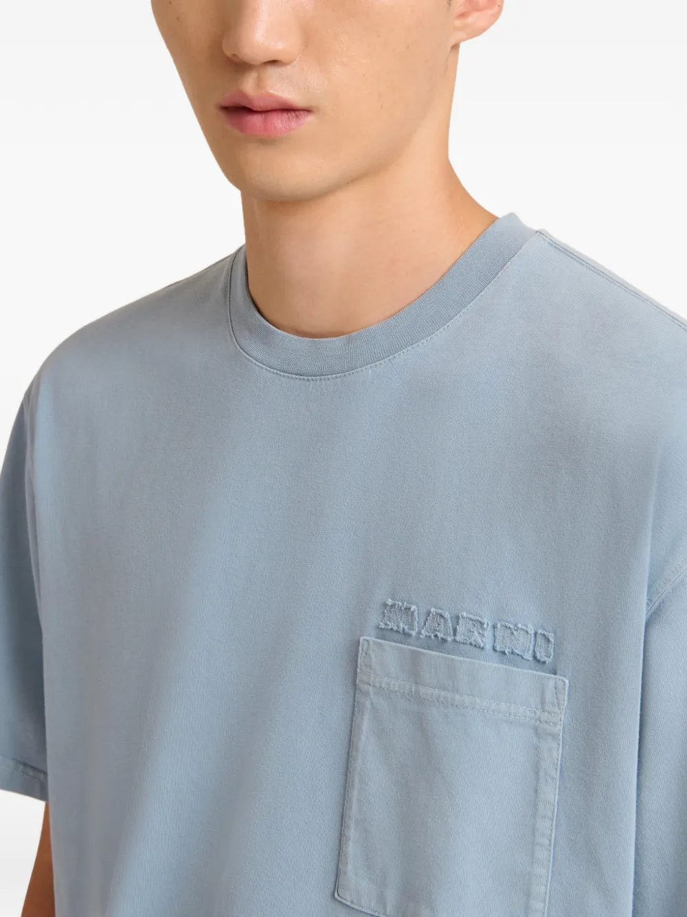 Close up of blue t-shirt, showing texture of the Cotton fabric