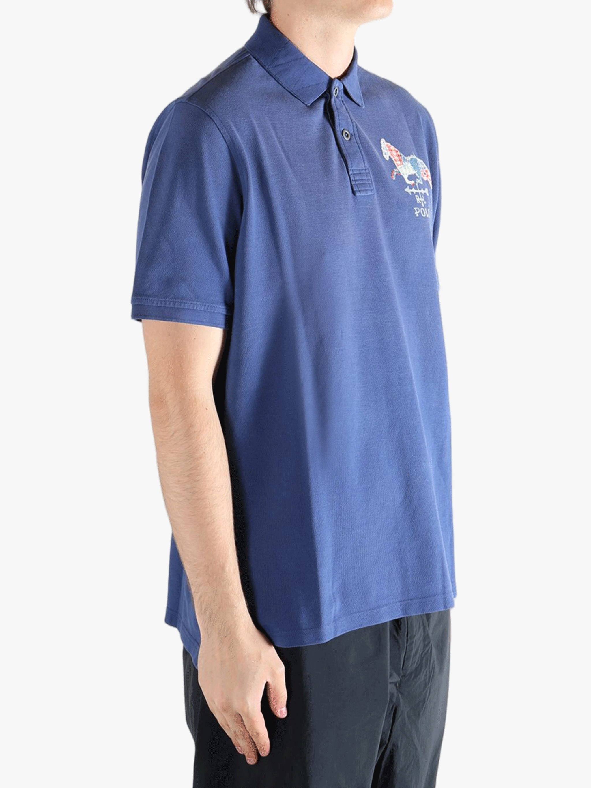 Blue polo shirt worn by a person, showing the shirt's fit