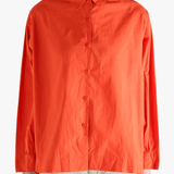 Red shirt worn by a person, showing the shirt's fit