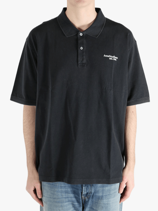 Black t-shirt worn by a person, showing the cotton fit