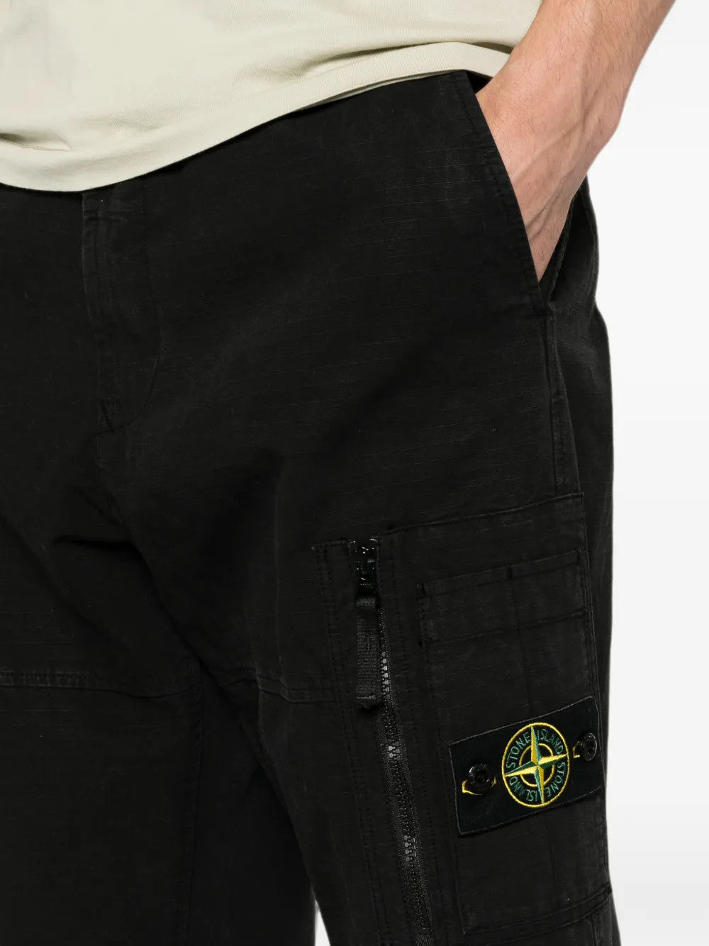 Black pants worn by a person, showing the pants fit