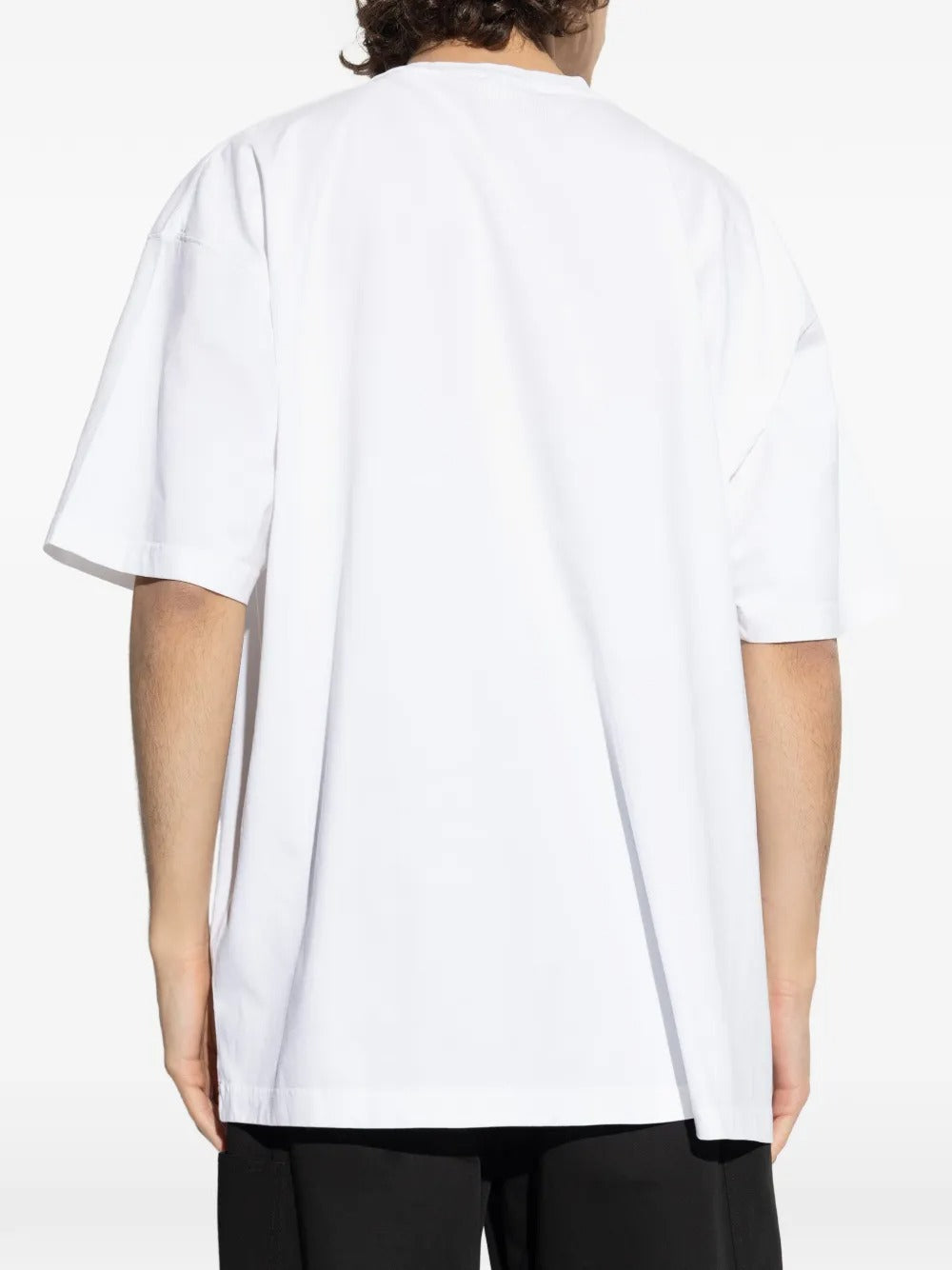 White t-shirt worn by a person, showing the shirt's fit