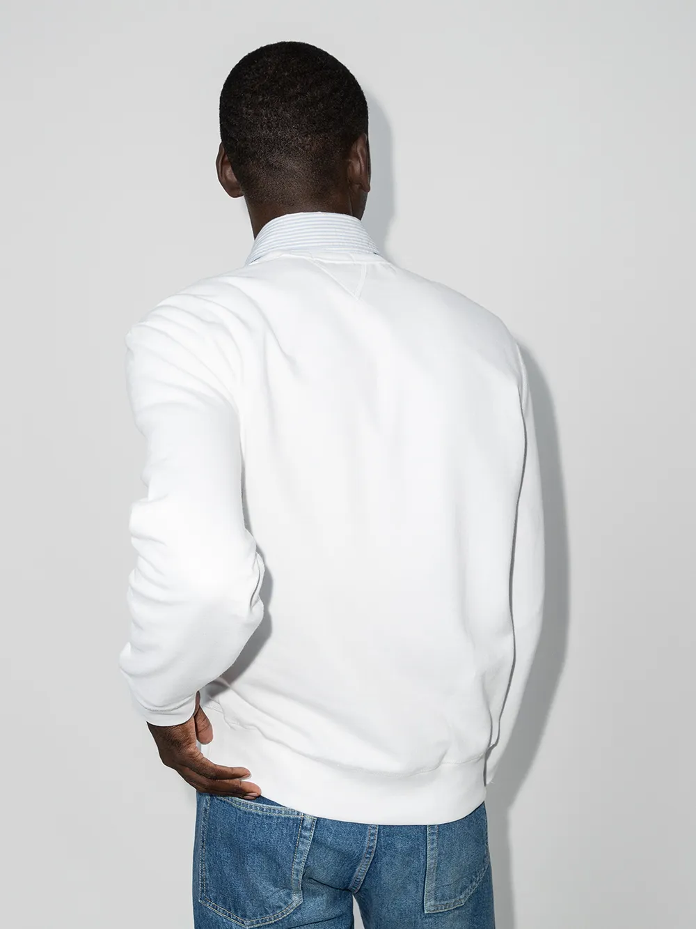 White sweatshirt worn by a person, showing the sweatshirt fit