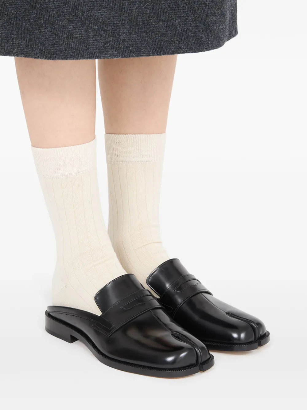 Black shoes worn by a person, showing the shoes fit