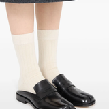 Black shoes worn by a person, showing the shoes fit