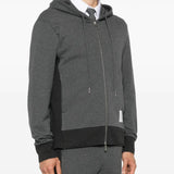 Grey hoodie worn by a person, showing the hoodie's fit