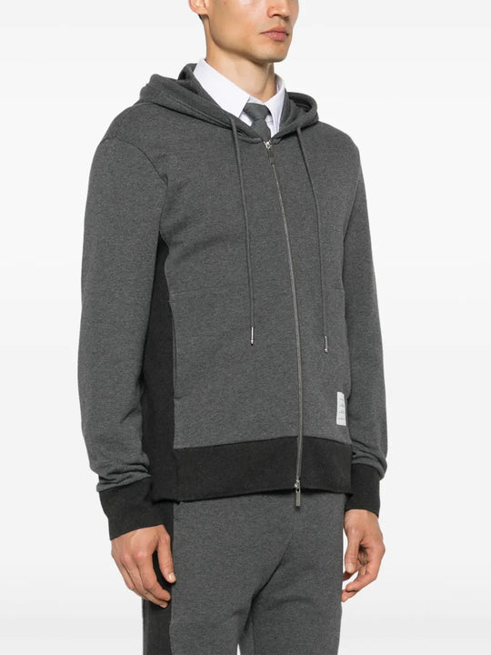 Grey hoodie worn by a person, showing the hoodie's fit