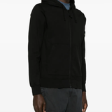 Black sweater worn by a person, showing the sweater's fit
