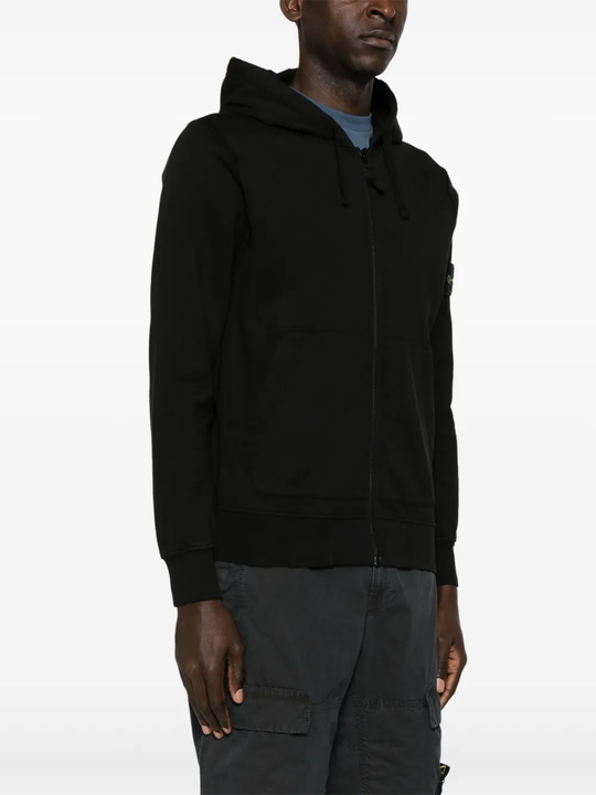 Black sweater worn by a person, showing the sweater's fit