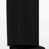 Close up of black pants, showing texture of the wool fabric