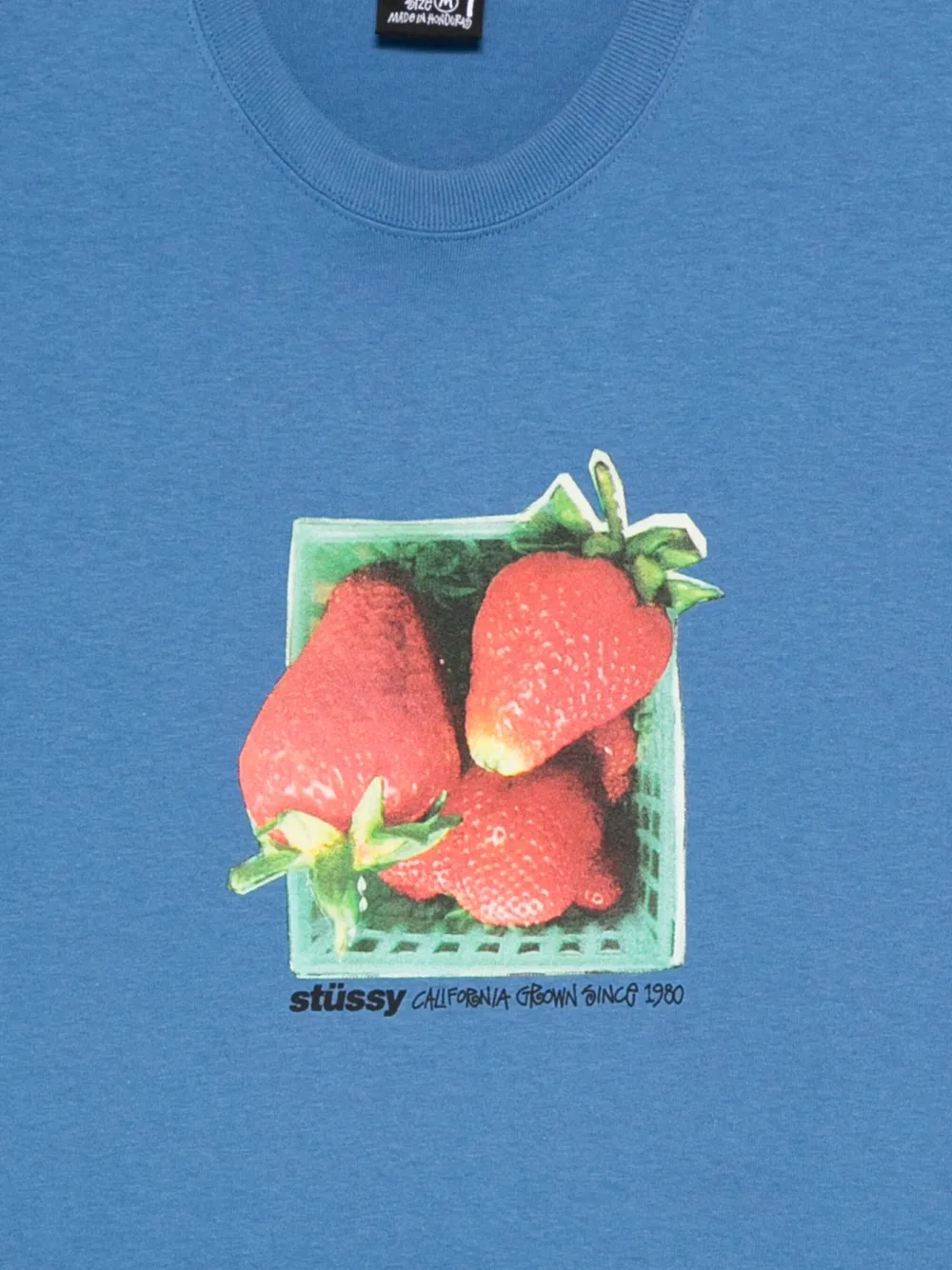 Close up of blue t-shirt, showing texture of the cotton fabric