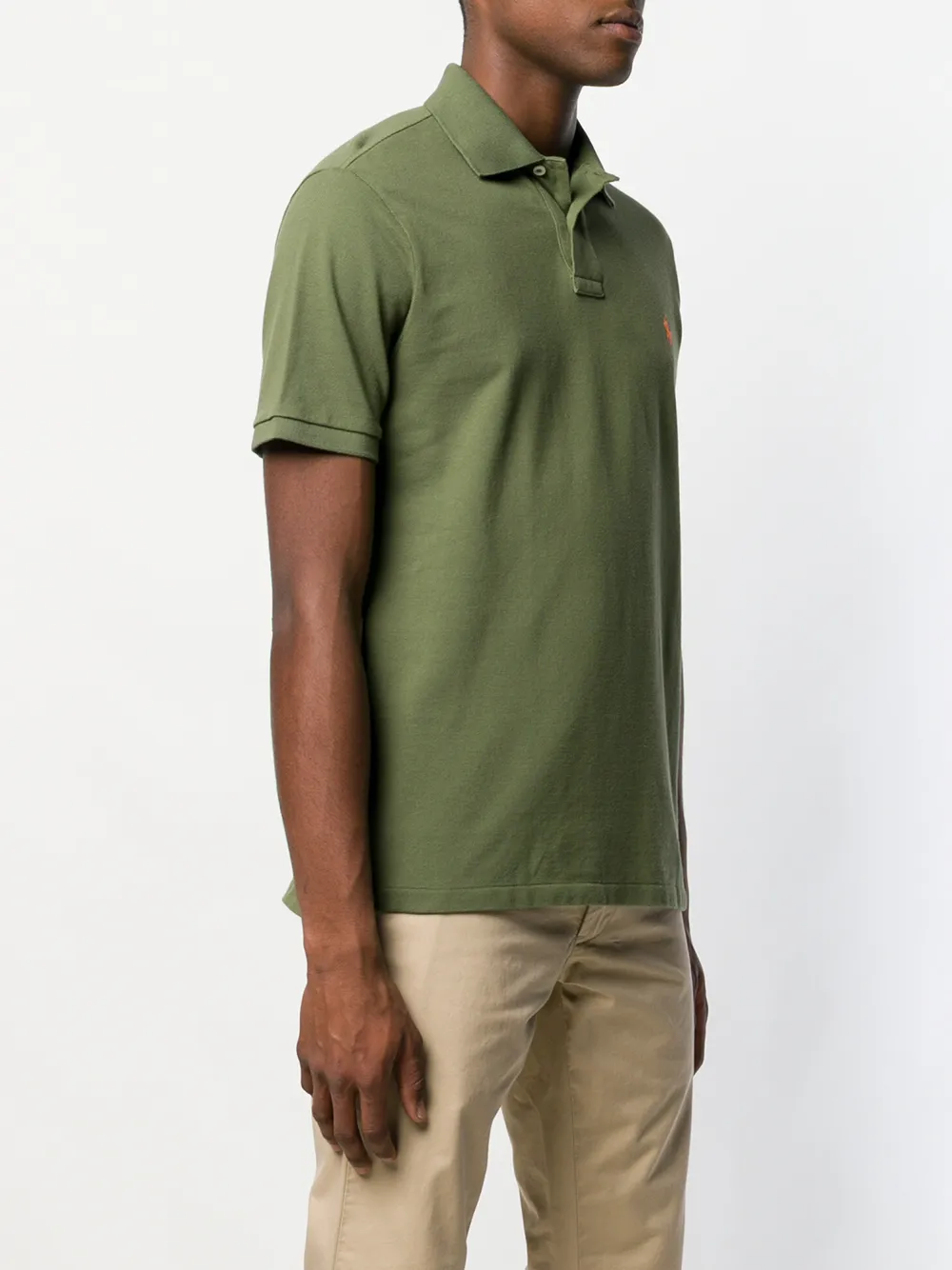 Green t-shirt worn by a person, showing the t-shirt fit