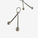 Close up of the silver earrings, showing texture of the silver fabric