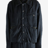 Black jacket worn a person, showing the jacket's fit