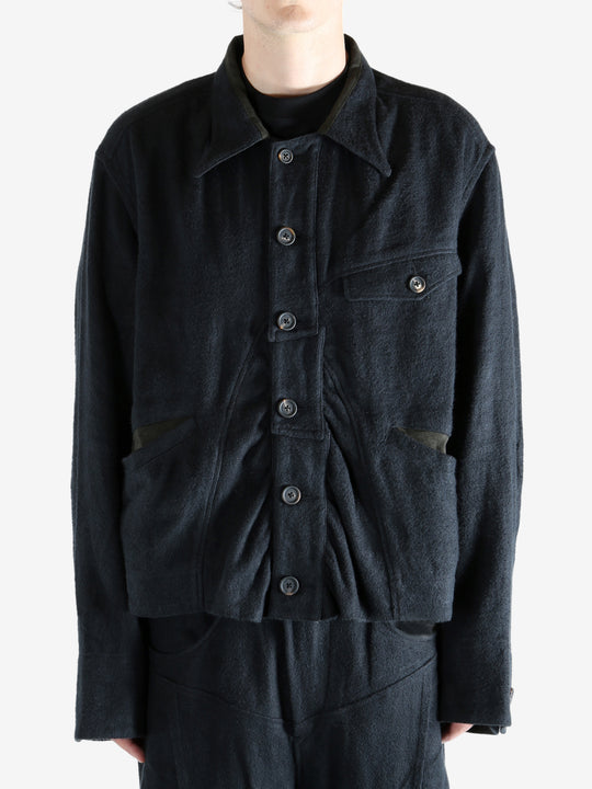 Black jacket worn a person, showing the jacket's fit