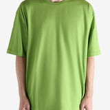 Green t-shirt worn by a person, showing the shirt's fit