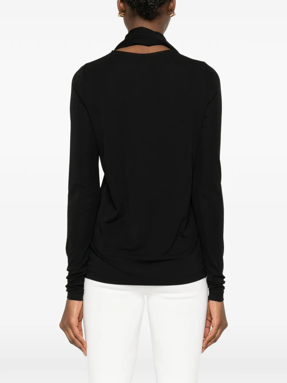 Black tops worn by a person, showing the tops' fit