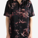 Black shirt worn by a person, showing the shirt's fit