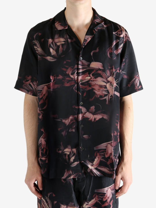 Black shirt worn by a person, showing the shirt's fit