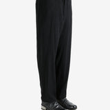 Black pants worn by a person, showing the pants's fit