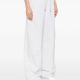 White pants worn by a person, showing the pants' fit