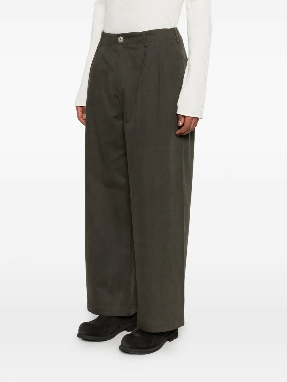 Green pants worn by a person, showing the pants's fit