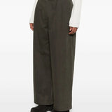 Green pants worn by a person, showing the pants's fit