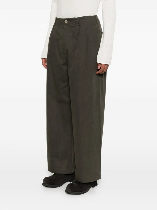 Green pants worn by a person, showing the pants's fit