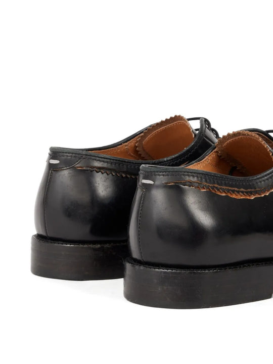 Close up of black shoes, showing texture of the leather fabric