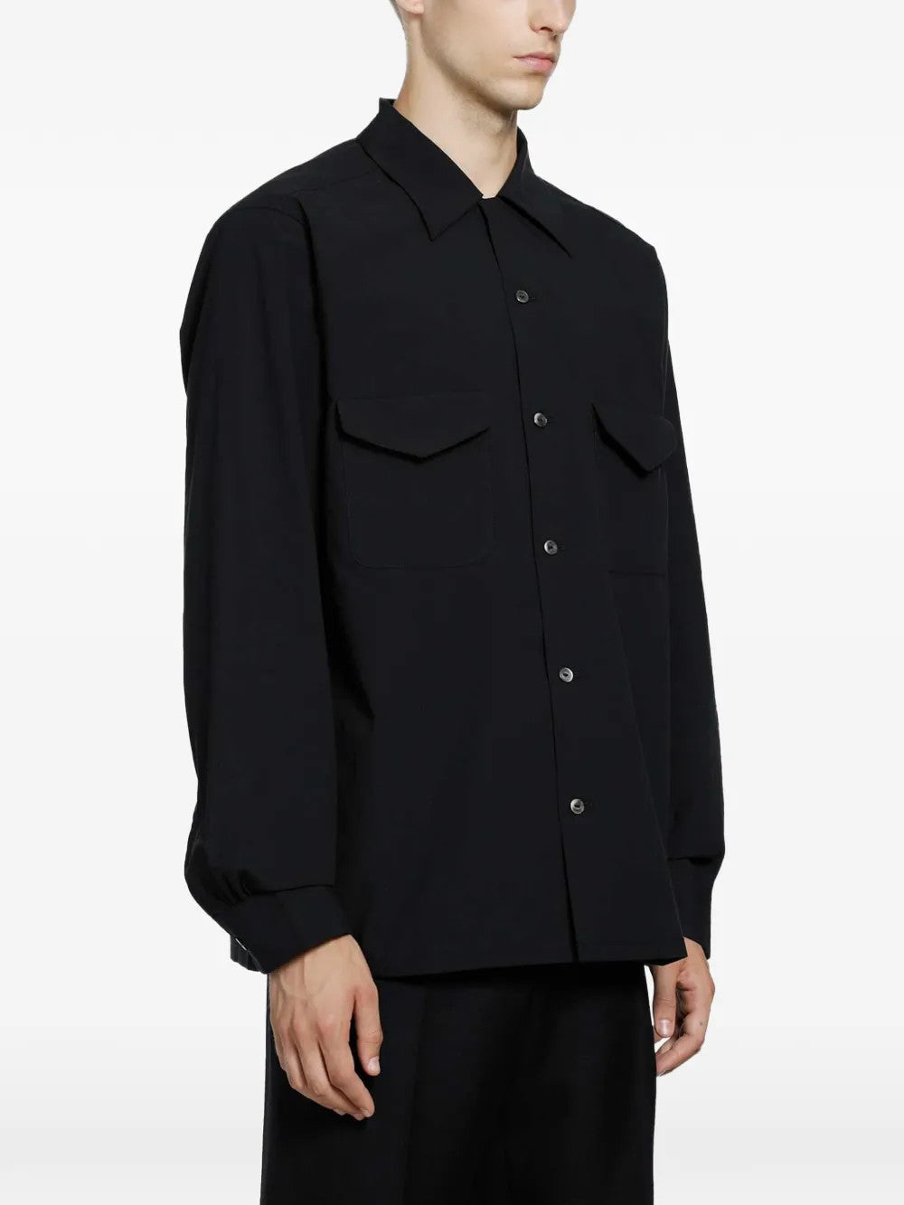 Black shirt worn by a person, showing the shirt fit