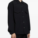 Black shirt worn by a person, showing the shirt fit