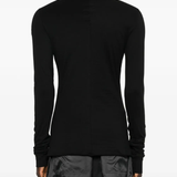 Black shirt worn by a person, showing the shirt fit