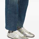 Grey sneakers worn by a person, showing the sneakers fit