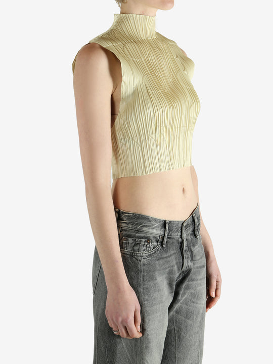green pleated top worn by a person, showing the top fit