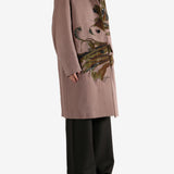 Pink coat worn by a person, showing the coat's fit