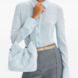 Blue bag carried by a person, showing the bag’s fit