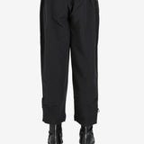 Black pants worn by a person, showing the pant’s fit