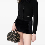 black knitwer worn by a person, showing the knitwer fit