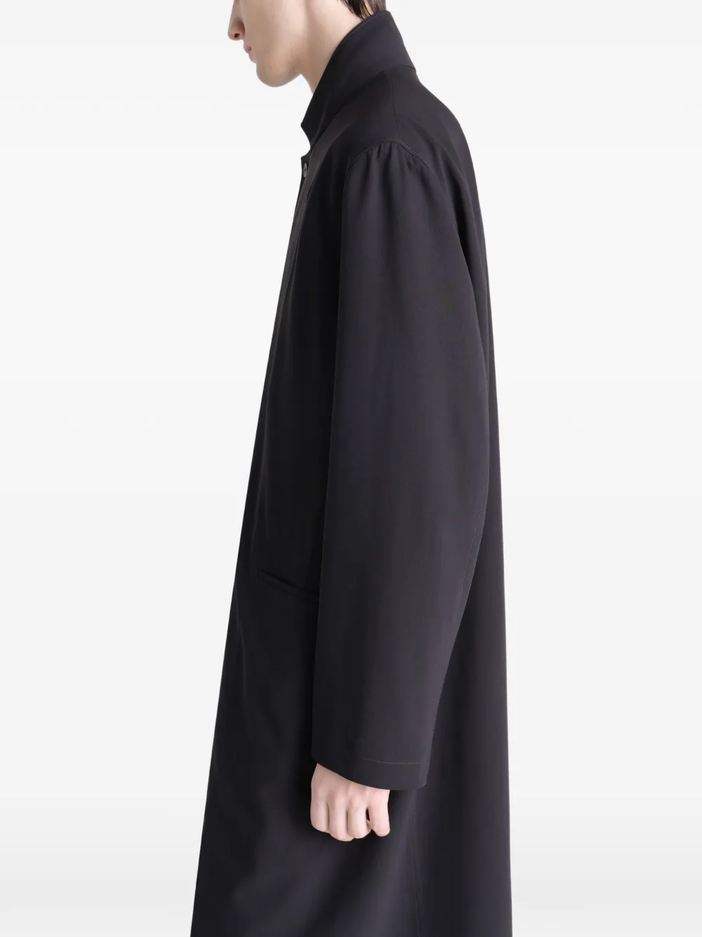 Black coats worn by a person, showing the coats fit