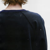 Close up of the black sweatshirt, showing texture of the cotton fabric