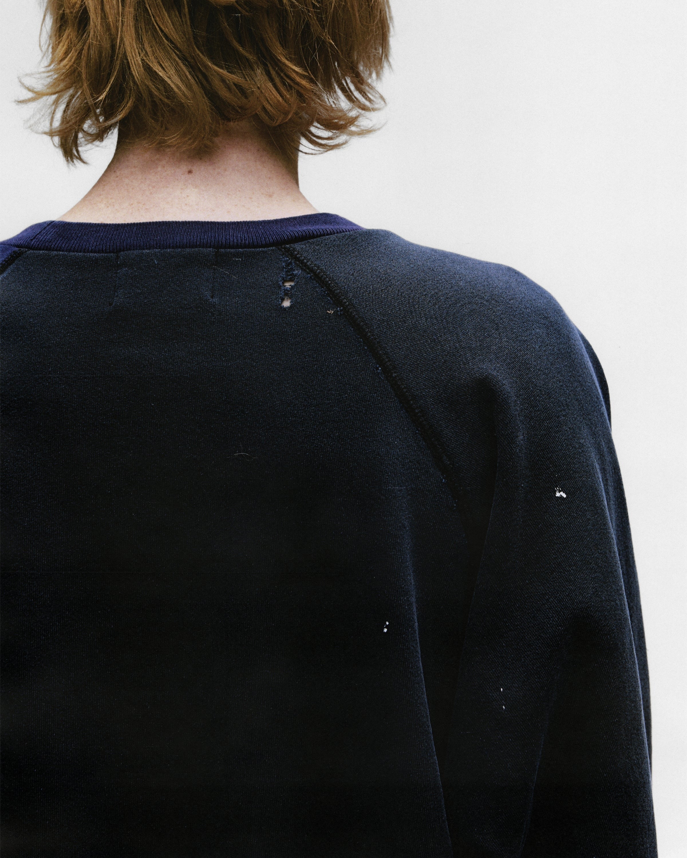 Close up of the black sweatshirt, showing texture of the cotton fabric