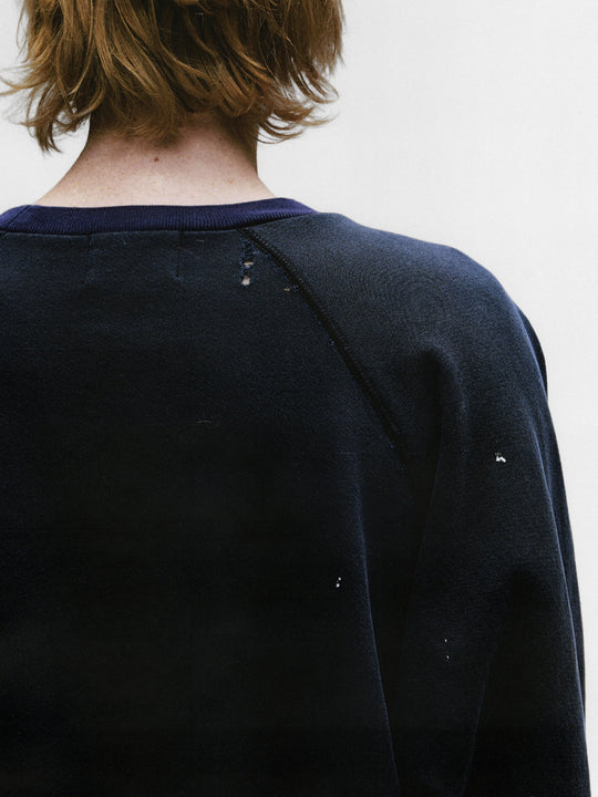 Close up of the black sweatshirt, showing texture of the cotton fabric