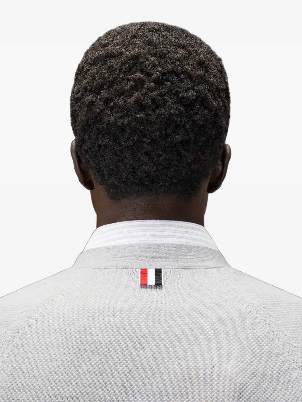 White knitwear worn by a person, showing the knitwear fit
