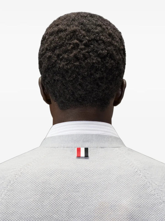 White knitwear worn by a person, showing the knitwear fit