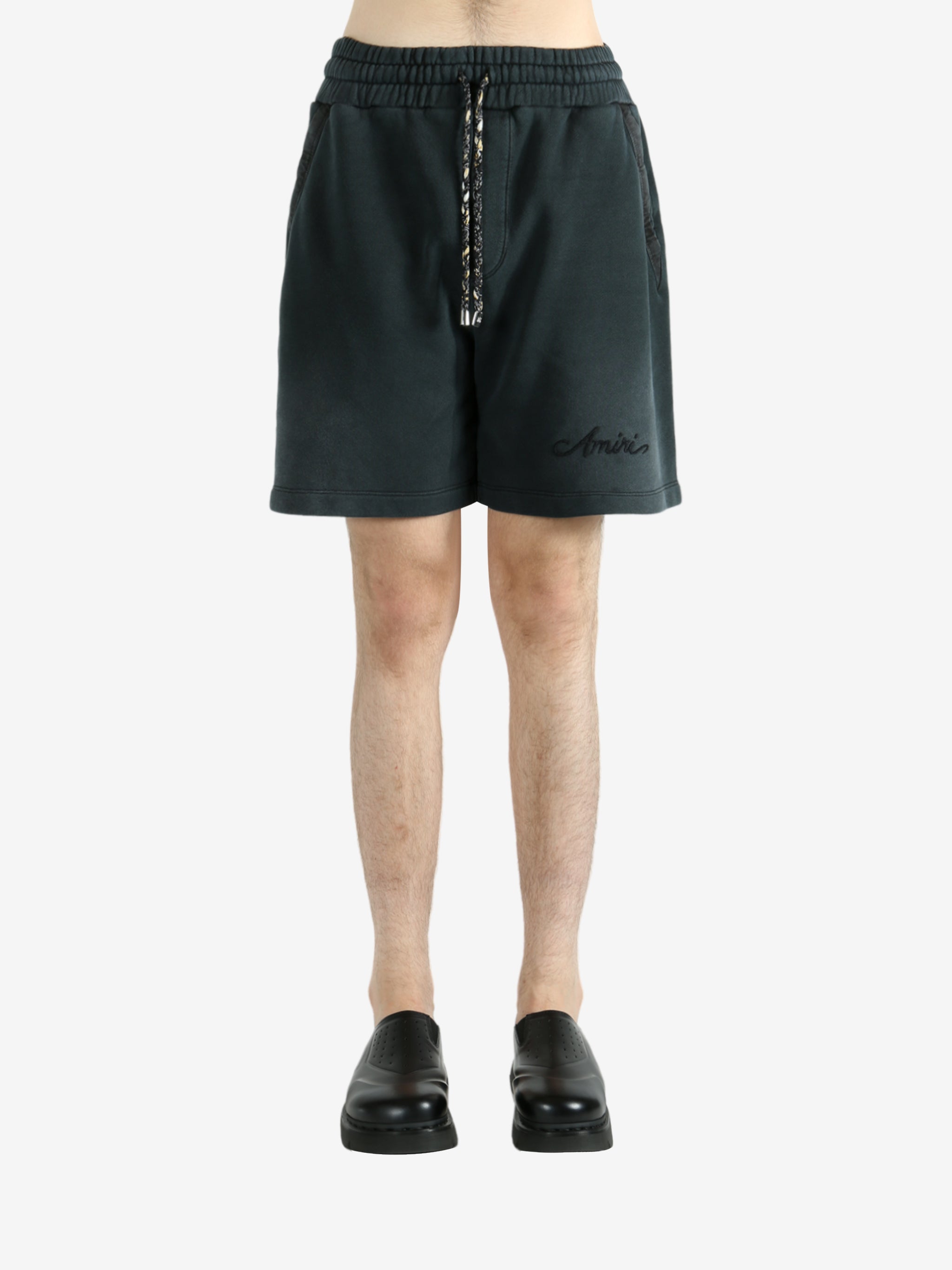 Black shorts worn by a person, showing the shorts’ fit