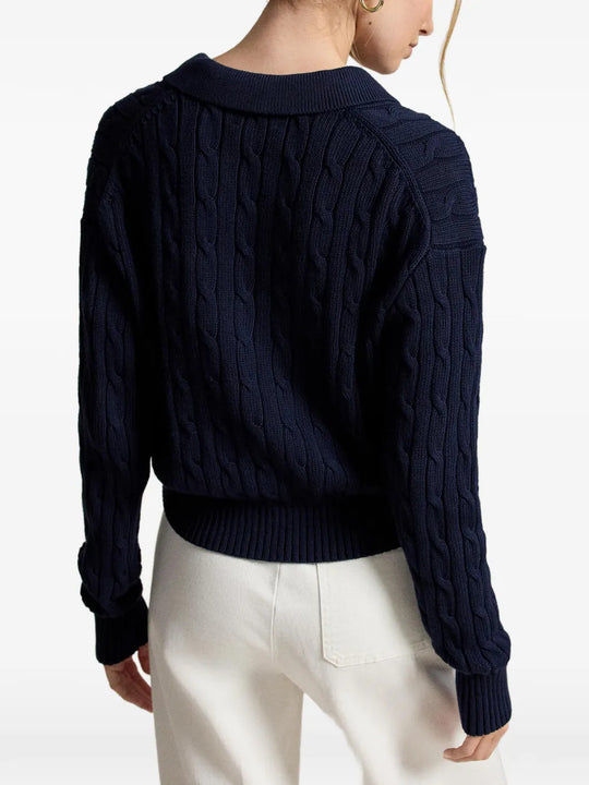 Navy knitwear worn by a person, showing the knitwear fit