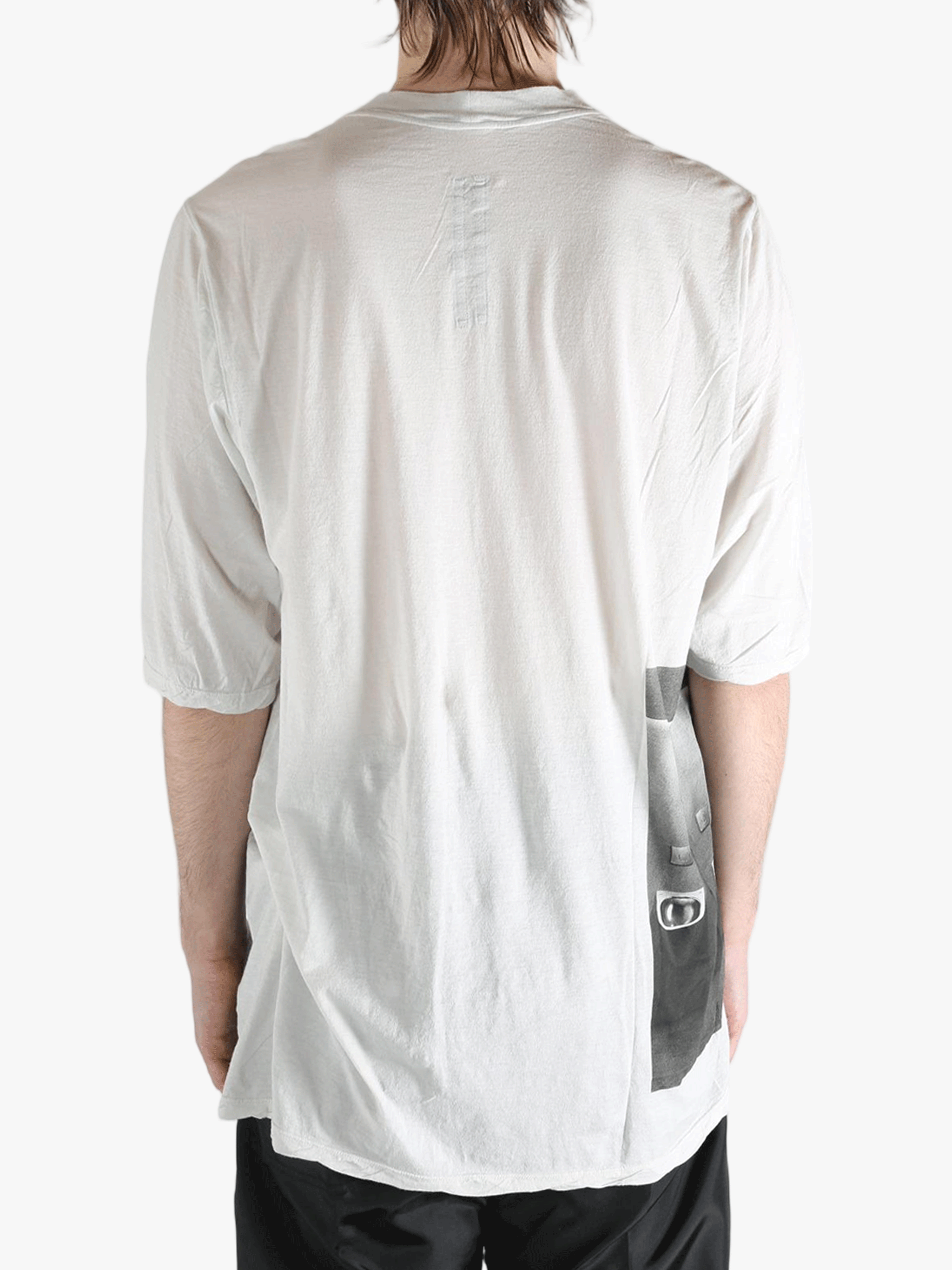 White t-shirt worn by a person, showing the t-shirt's fit