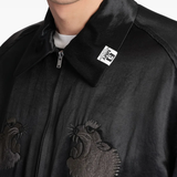 Close up of the black jacket, showing texture of the acetate fabric