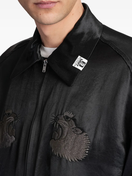 Close up of the black jacket, showing texture of the acetate fabric